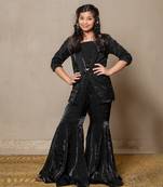 Chic black velvet ensemble with a stylish blazer and flared pants