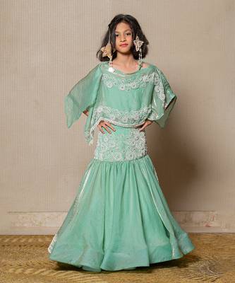 Elegant mint green top and lehenga with intricate white embroidery and a flowing silhouette 1