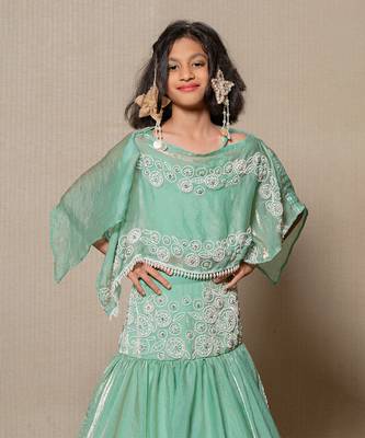 Elegant mint green top and lehenga with intricate white embroidery and a flowing silhouette 2