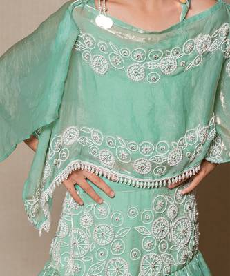 Elegant mint green top and lehenga with intricate white embroidery and a flowing silhouette 3