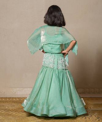 Elegant mint green top and lehenga with intricate white embroidery and a flowing silhouette 4