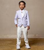 Trendy lavender blazer with metallic stud embellishments paired with classic white trousers