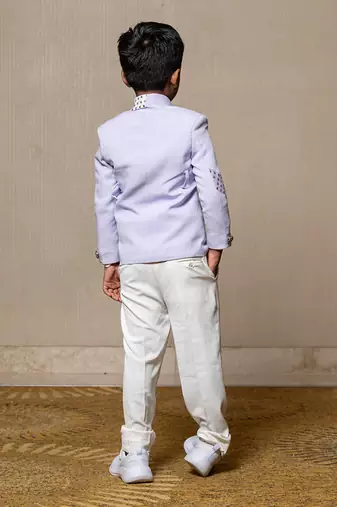 Trendy lavender blazer with metallic stud embellishments paired with classic white trousers
