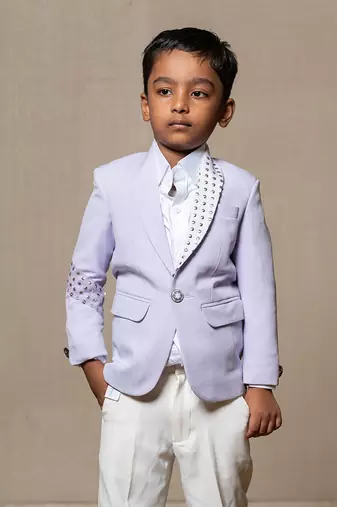 Trendy lavender blazer with metallic stud embellishments paired with classic white trousers