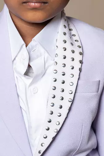 Trendy lavender blazer with metallic stud embellishments paired with classic white trousers