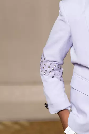 Trendy lavender blazer with metallic stud embellishments paired with classic white trousers