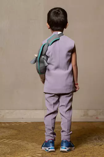 Stylish sleeveless lavender blazer with a modern asymmetrical white lapel, paired with matching slim-fit trousers