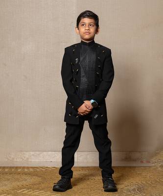 Modern blacksuit with embroidered gold accents and a high mandarin collar 1
