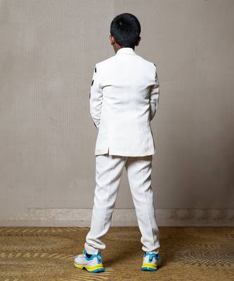 Modern off-white suit with blackaccents and stylish embroidered sleeve detail 2