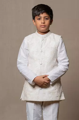 Ivory embroidered nehru jacket paired with a classic white shirt and pants