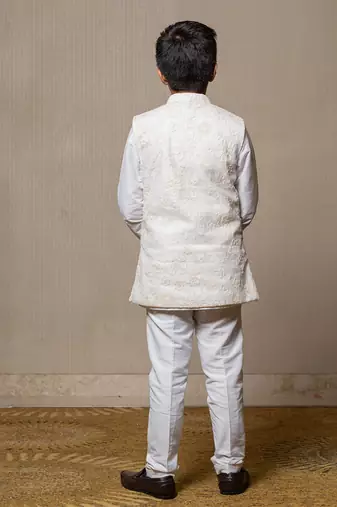 Ivory embroidered nehru jacket paired with a classic white shirt and pants