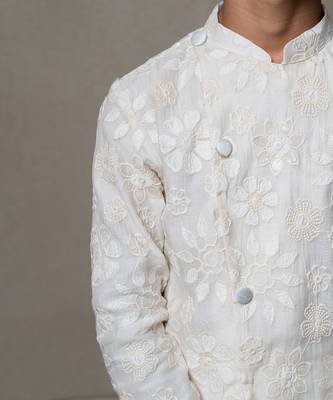 Intricately embroidered off-white bandhgala with matching white kurta and pants 3
