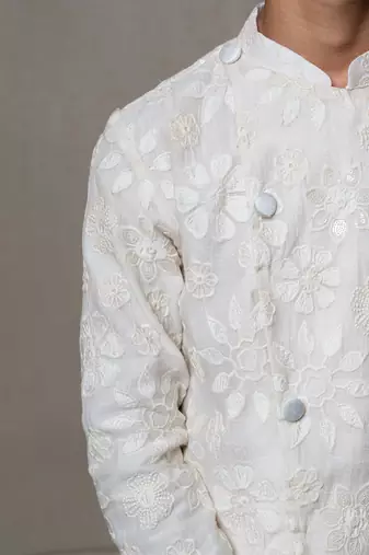 Intricately embroidered off-white bandhgala with matching white kurta and pants