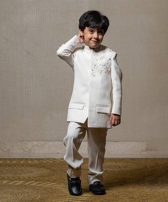 Ivory white bandhgala jacket with intricate pearl and sequin embellishments paired with matching straight-fit pants 1