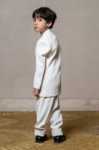 Ivory white bandhgala jacket with intricate pearl and sequin embellishments paired with matching straight-fit pants