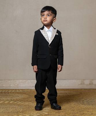 Classic black blazer with a champagne metallic-textured lapel, paired with matching pants and a crisp white shirt 1