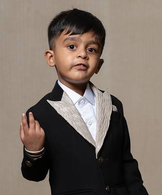 Classic black blazer with a champagne metallic-textured lapel, paired with matching pants and a crisp white shirt 2