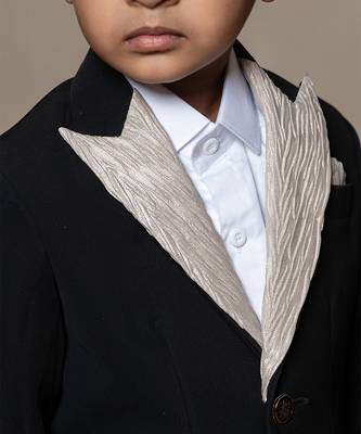 Classic black blazer with a champagne metallic-textured lapel, paired with matching pants and a crisp white shirt 3