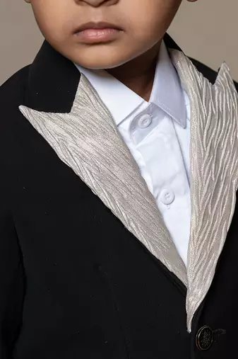 Classic black blazer with a champagne metallic-textured lapel, paired with matching pants and a crisp white shirt
