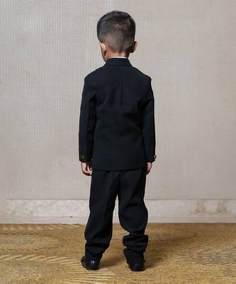 Classic black blazer with a champagne metallic-textured lapel, paired with matching pants and a crisp white shirt 4