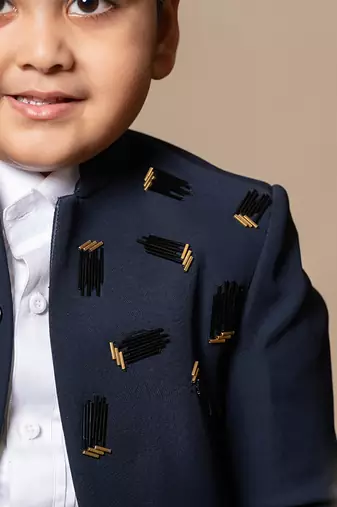 Navy blue blazer with elegant metallic embroidery, paired with matching trousers and a crisp white shirt