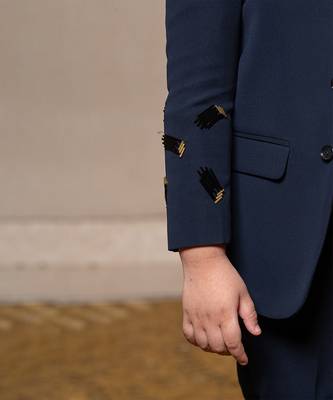 Navy blue blazer with elegant metallic embroidery, paired with matching trousers and a crisp white shirt 5