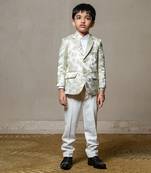 Elegant cream blazer with intricate green floral embroidery, paired with matching trousers and a crisp white shirt