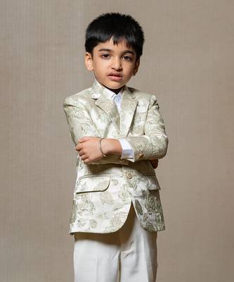 Elegant cream blazer with intricate green floral embroidery, paired with matching trousers and a crisp white shirt 2