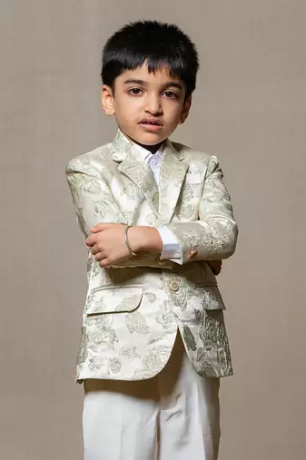 Elegant cream blazer with intricate green floral embroidery, paired with matching trousers and a crisp white shirt