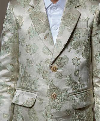 Elegant cream blazer with intricate green floral embroidery, paired with matching trousers and a crisp white shirt 3