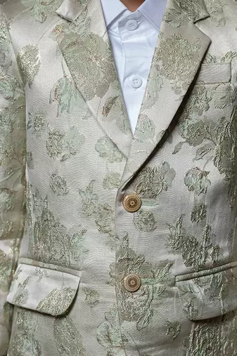 Elegant cream blazer with intricate green floral embroidery, paired with matching trousers and a crisp white shirt