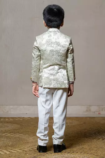 Elegant cream blazer with intricate green floral embroidery, paired with matching trousers and a crisp white shirt