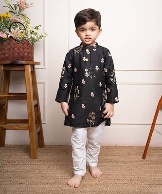 Elegant black kurta with floral embroidery paired with classic white churidar pants 1