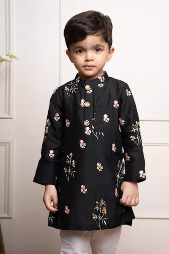 Elegant black kurta with floral embroidery paired with classic white churidar pants
