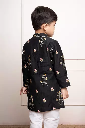 Elegant black kurta with floral embroidery paired with classic white churidar pants