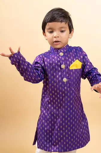 Vibrant purple kurta with golden motifs and yellow pocket square, paired with classic white churidar pants