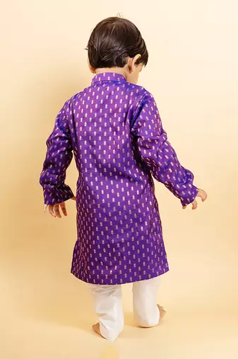 Vibrant purple kurta with golden motifs and yellow pocket square, paired with classic white churidar pants