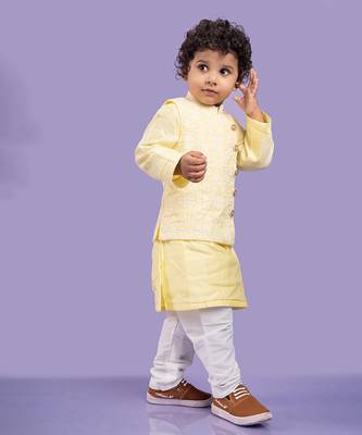 Elegant soft yellow kurta with intricate white embroidery, paired with classic white churidar pants 1
