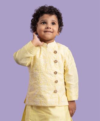 Elegant soft yellow kurta with intricate white embroidery, paired with classic white churidar pants 2