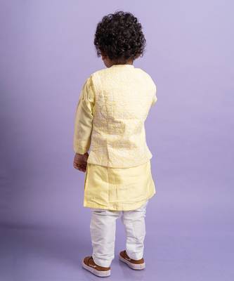 Elegant soft yellow kurta with intricate white embroidery, paired with classic white churidar pants 3