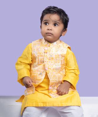 Vibrant yellow kurta set with an embroidered peach nehru jacket, paired with classic white churidar pants 2