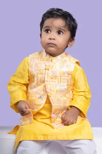 Vibrant yellow kurta set with an embroidered peach nehru jacket, paired with classic white churidar pants