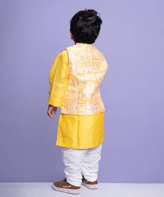 Vibrant yellow kurta set with an embroidered peach nehru jacket, paired with classic white churidar pants 3