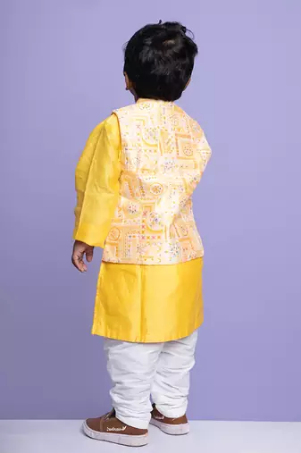 Vibrant yellow kurta set with an embroidered peach nehru jacket, paired with classic white churidar pants