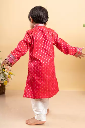 Elegant red kurta with golden embroidery paired with classic white pants