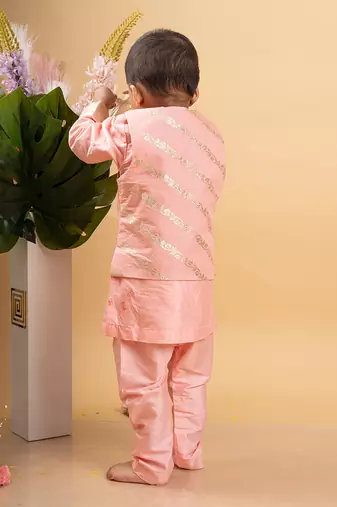 Elegant soft peach kurta set with a regal golden-detailed jacket