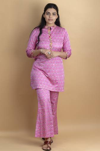 Pink co ord set with hand work embellished top and bell shaped bottoms on pure ajrakh fabric
