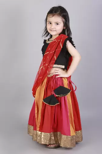 Black ruffled blouse with multi color lehnga