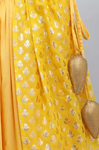 Mustard blouse with attached net dupatta and double layered lehnga