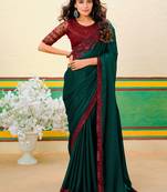 Dark green embroidered heavy partywear saree
